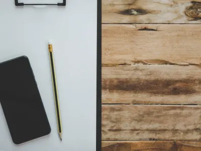 Organized desk workspace with laptop, notebook, and office supplies