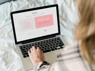 A laptop displaying a clean, professional small business website on a desk