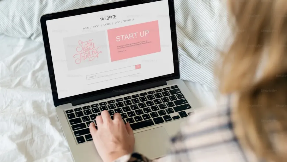 A laptop displaying a clean, professional small business website on a desk