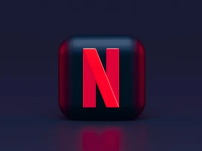 A smartphone displaying a Facebook business page next to a laptop showing a professional website