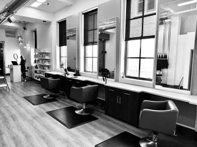 Salon interior with styling chairs and mirrors in a modern barbershop setting