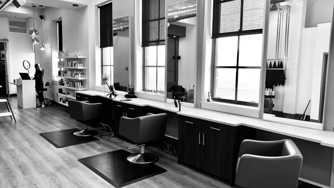 Salon interior with styling chairs and mirrors in a modern barbershop setting