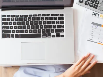 Woman reviewing documents and costs at her desk