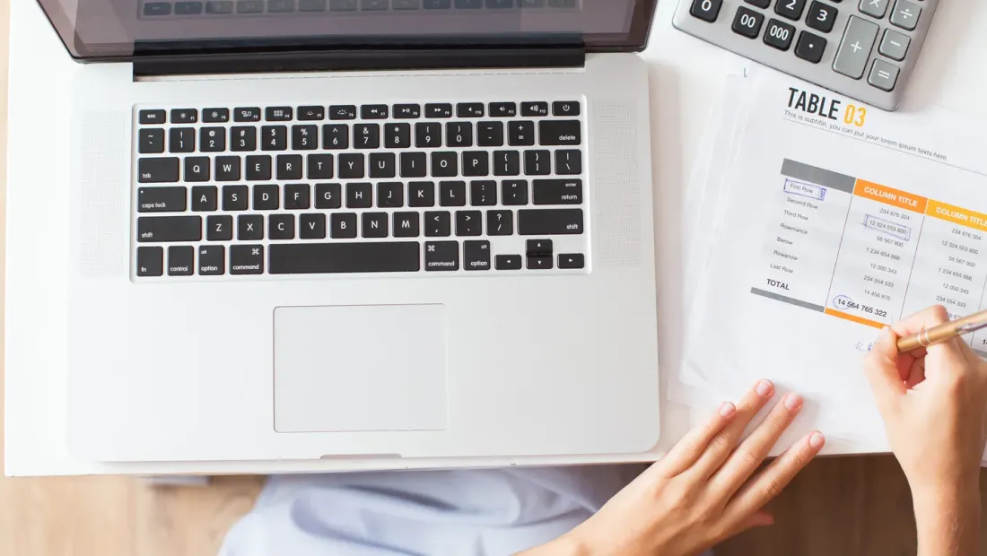 Woman reviewing documents and costs at her desk
