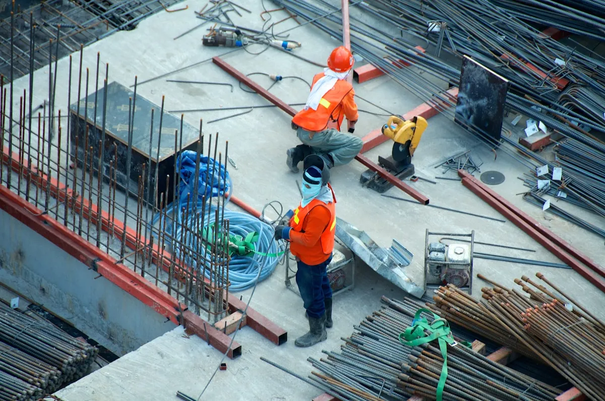 A construction worker reviewing project photos on a tablet at a job site